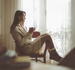 sad woman starting out window