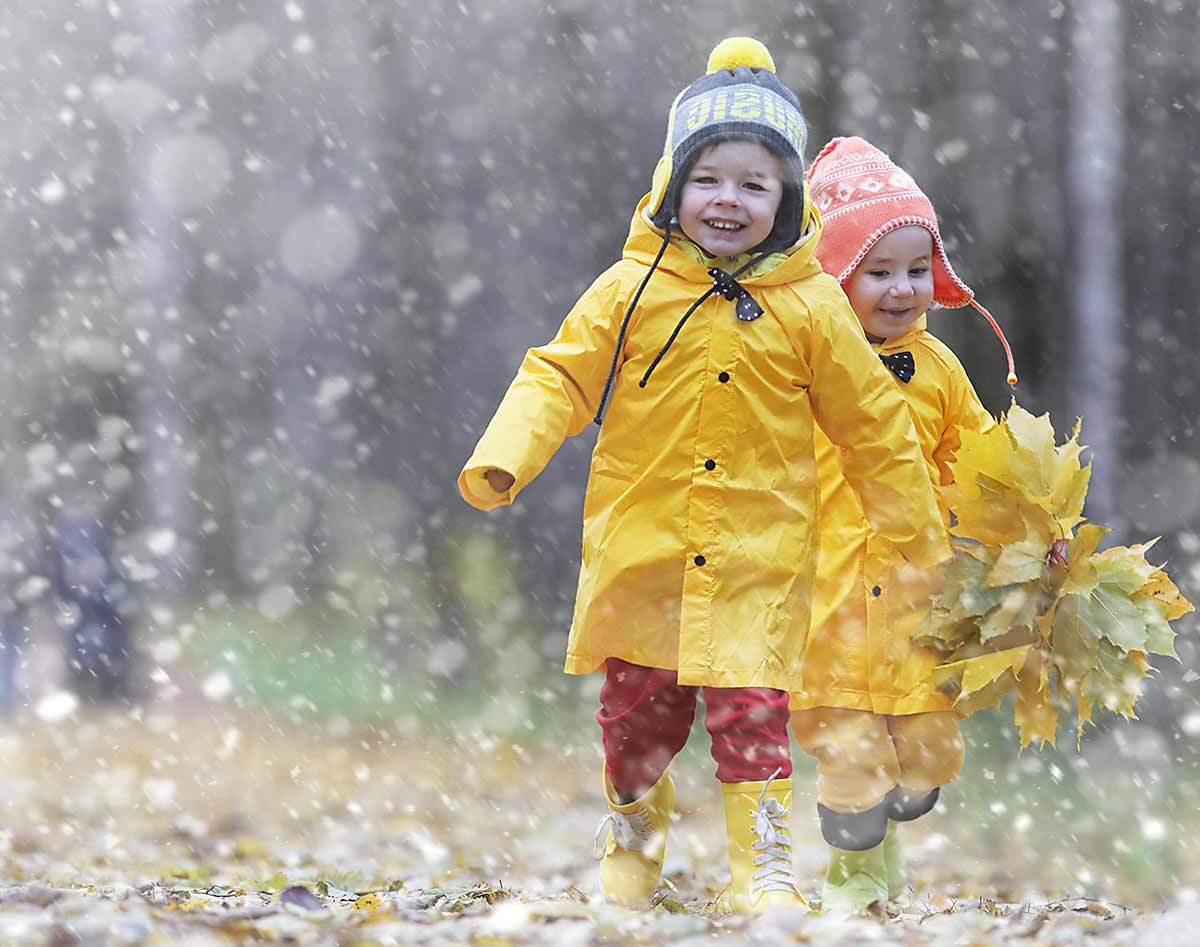 Children laughing and playing in the rain