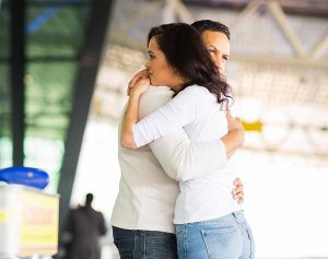 Separated couple hugging