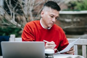Man in red checking paperwork