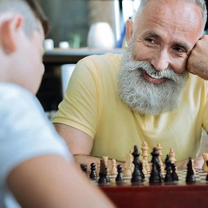 grandad and grandson playing chess